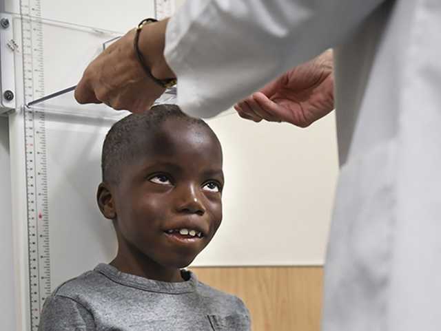 Child getting height measured.