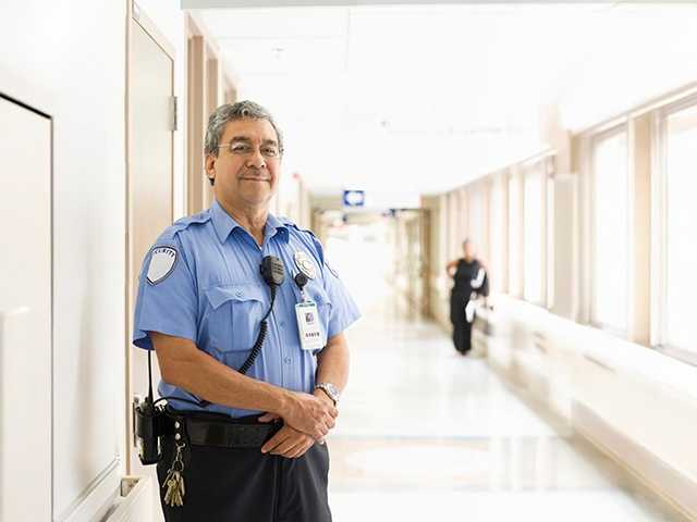 security guard standing in the hallways of the hospital providing security services for patients and staff