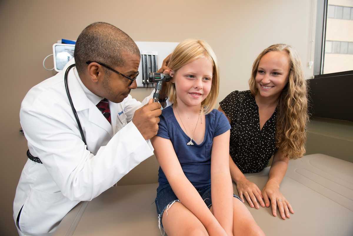 Dr. Osman treating a child patient