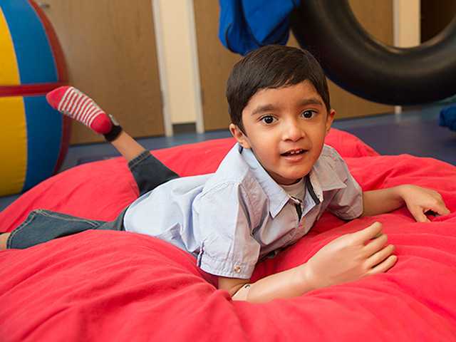 A young boy smiling for the camera while at the treatment center.