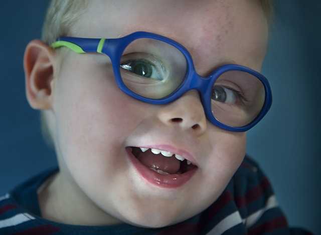 Smiling young boy wearing glasses