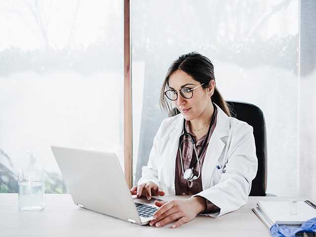 Image of doctor workng on her laptop