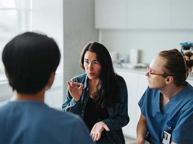 an interpreter is explaining something to a patient