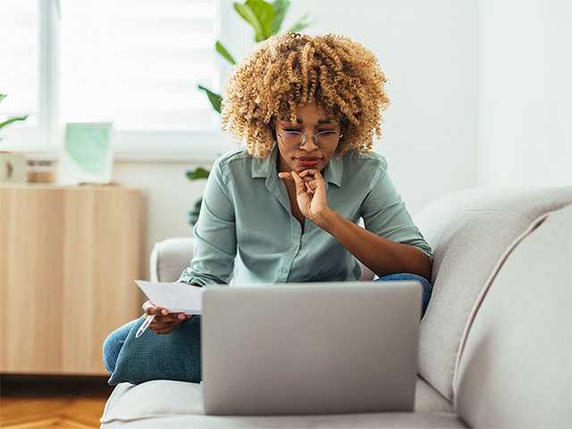 Woman with laptop enroll in medical insurance coverage