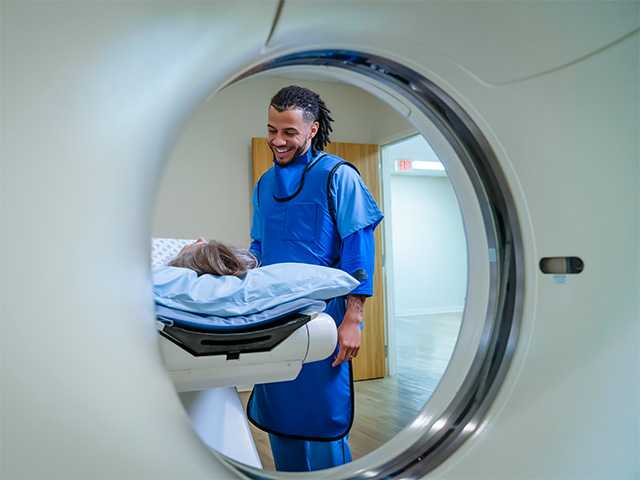Woman lies down inside an MRI machine getting cardiovascular imaging done