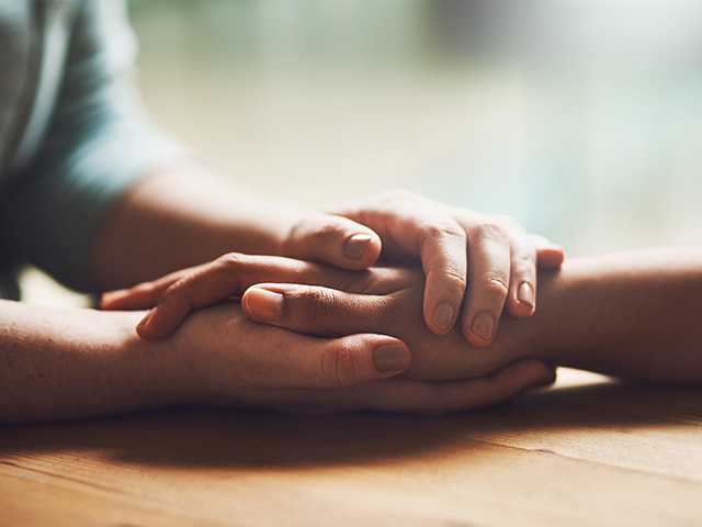 Two people supporting each other during a hard time