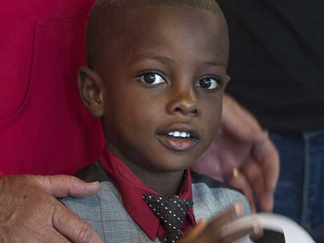 fillerClose-up of smiling boy with adults behind him